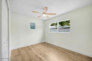 57 Riverview Ln, Cocoa Beach, FL 32931 - empty room featuring wood finished floors and ceiling fan