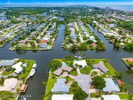 57 Riverview Ln, Cocoa Beach, FL 32931 - aerial overview of property's location featuring nearby suburban area and a large body of water