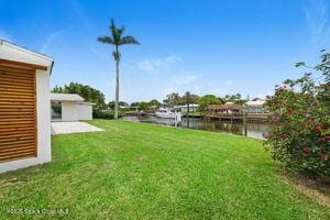 57 Riverview Ln, Cocoa Beach, FL 32931 - view of green lawn featuring a water view