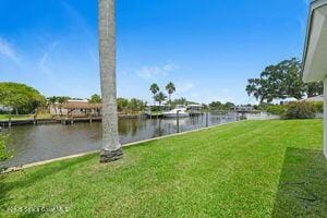 57 Riverview Ln, Cocoa Beach, FL 32931 - view of green lawn with a water view