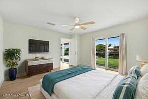 57 Riverview Ln, Cocoa Beach, FL 32931 - bedroom featuring access to exterior and ceiling fan