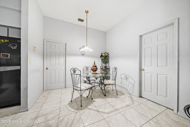 2180 Figtree Dr Unit 0, Titusville, FL 32780 - dining area featuring light tile patterned floors and vaulted ceiling