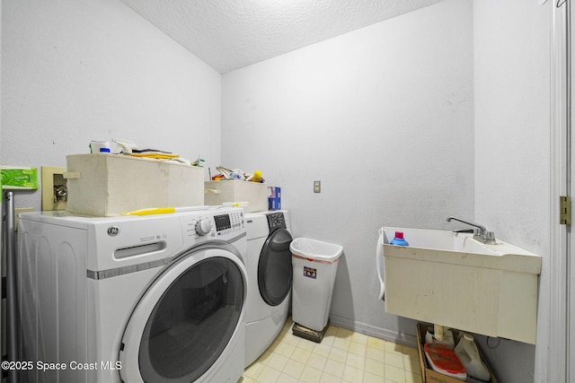 2180 Figtree Dr Unit 0, Titusville, FL 32780 - washroom featuring washing machine and clothes dryer, a textured ceiling, and light tile patterned floors