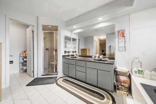 2180 Figtree Dr Unit 0, Titusville, FL 32780 - bathroom with vanity, a stall shower, tile patterned floors, recessed lighting, and a bath
