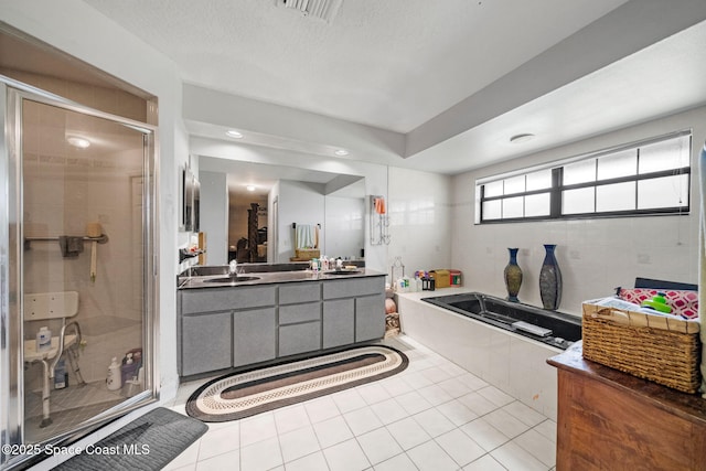 2180 Figtree Dr Unit 0, Titusville, FL 32780 - bathroom with a garden tub, a stall shower, double vanity, and tile patterned flooring