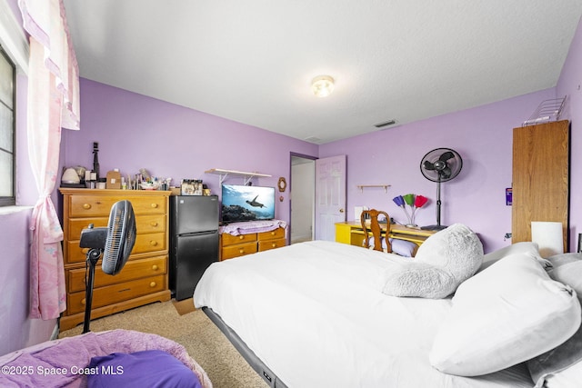 2180 Figtree Dr Unit 0, Titusville, FL 32780 - bedroom featuring freestanding refrigerator and light colored carpet