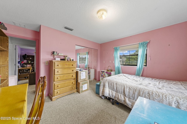 2180 Figtree Dr Unit 0, Titusville, FL 32780 - carpeted bedroom featuring a closet and a textured ceiling