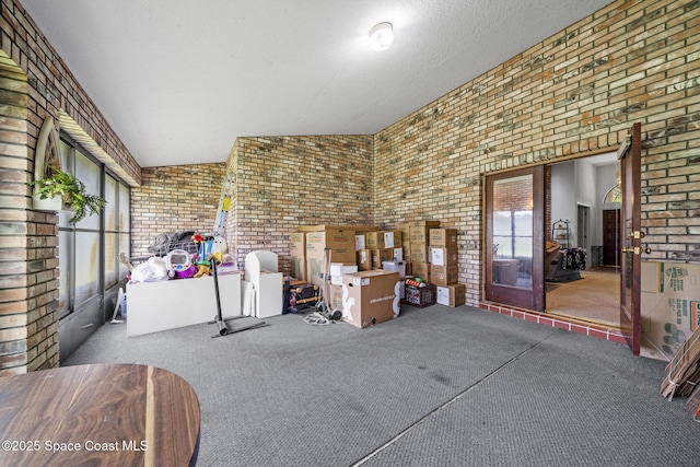 2180 Figtree Dr Unit 0, Titusville, FL 32780 - living area with brick wall, carpet flooring, and a textured ceiling