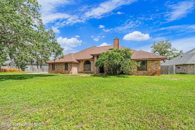 2180 Figtree Dr Unit 0, Titusville, FL 32780 - rear view of property with brick siding, a chimney, and roof with shingles