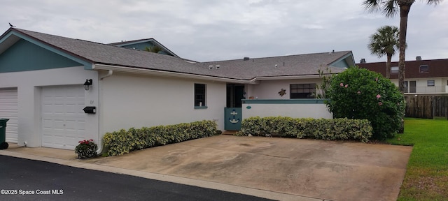 290 Paradise Blvd # 84, Indialantic, FL 32903 - view of front of property featuring stucco siding, a garage, and roof with shingles
