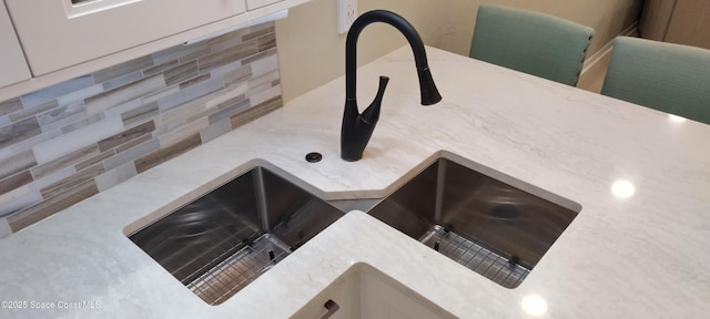 290 Paradise Blvd # 84, Indialantic, FL 32903 - kitchen view of a sink, decorative backsplash, and light stone counters