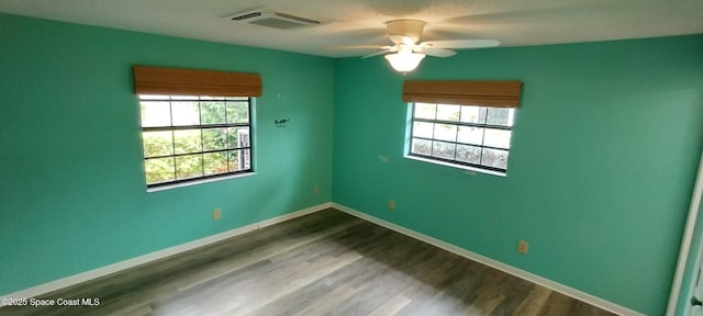 290 Paradise Blvd # 84, Indialantic, FL 32903 - spare room with a ceiling fan, dark wood-style flooring, and baseboards