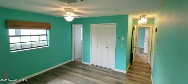 290 Paradise Blvd # 84, Indialantic, FL 32903 - unfurnished bedroom with wood finished floors, a closet, baseboards, and ceiling fan