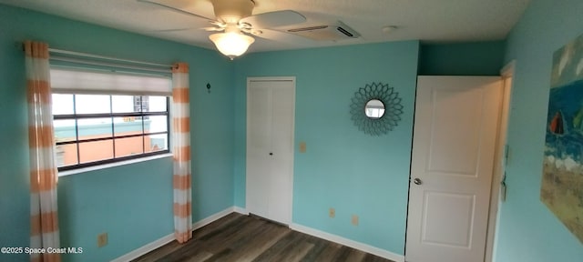 290 Paradise Blvd # 84, Indialantic, FL 32903 - unfurnished bedroom featuring dark wood finished floors, a closet, and baseboards