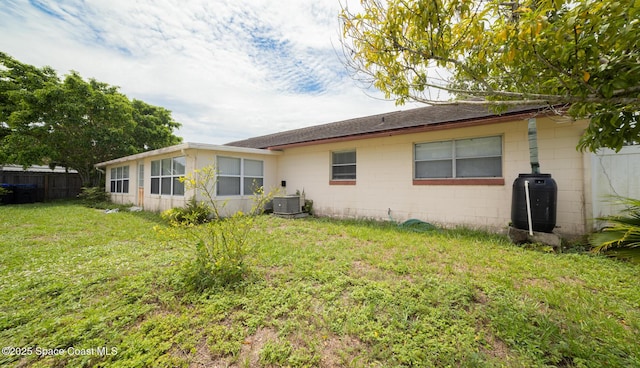 880 Williamsburg Dr, Titusville, FL 32780 - back of property with concrete block siding, central AC, and roof with shingles