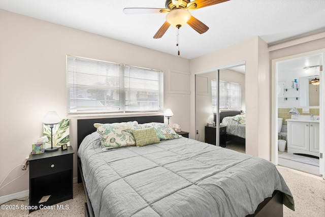 7515 Ridgewood Ave Unit 17A, Cape Canaveral, FL 32920 - bedroom with a closet, multiple windows, connected bathroom, and baseboards