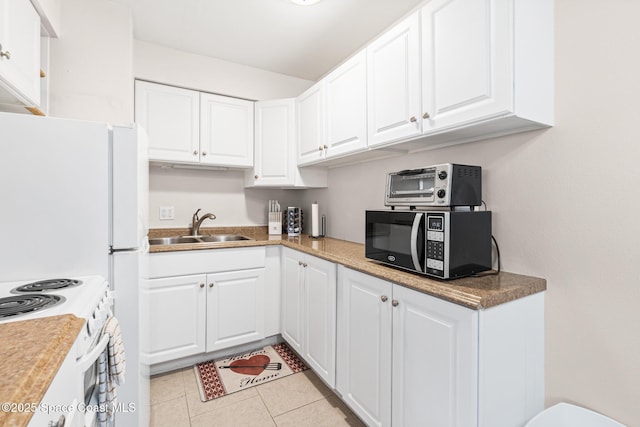 7515 Ridgewood Ave Unit 17A, Cape Canaveral, FL 32920 - kitchen with black microwave, a sink, white cabinetry, and light tile patterned flooring