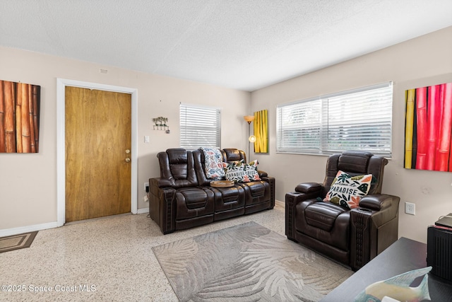 7515 Ridgewood Ave Unit 17A, Cape Canaveral, FL 32920 - living room with speckled floor, baseboards, and a textured ceiling