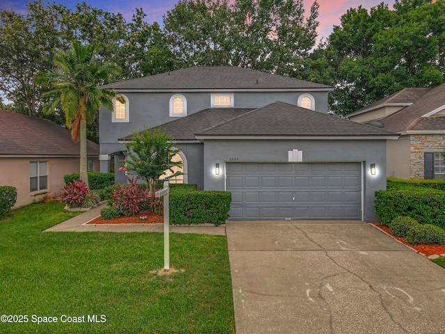 9525 Southern Garden Cir, Altamonte Springs, FL 32714 - traditional-style home featuring stucco siding, a garage, a front yard, driveway, and a shingled roof