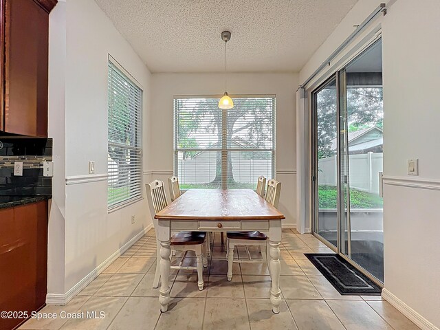 9525 Southern Garden Cir, Altamonte Springs, FL 32714 - dining area featuring a textured ceiling and light tile patterned floors