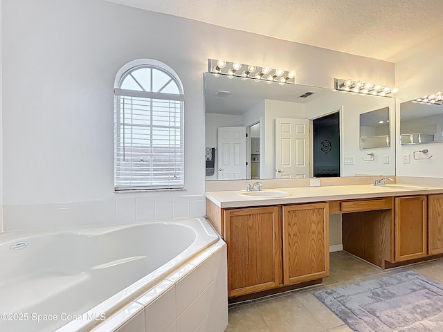 9525 Southern Garden Cir, Altamonte Springs, FL 32714 - full bath featuring double vanity, a bath, tile patterned floors, and a textured ceiling