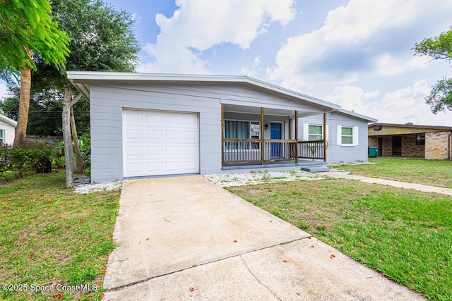 1108 Abington St, Cocoa, FL 32922 - view of front of property featuring covered porch, driveway, an attached garage, and a front lawn