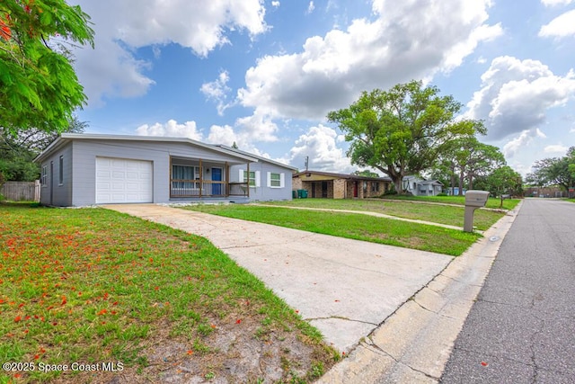 1108 Abington St, Cocoa, FL 32922 - view of front of home featuring an attached garage, driveway, and a front lawn