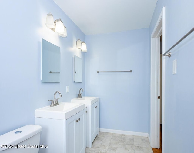 1108 Abington St, Cocoa, FL 32922 - full bath featuring toilet, two vanities, and baseboards