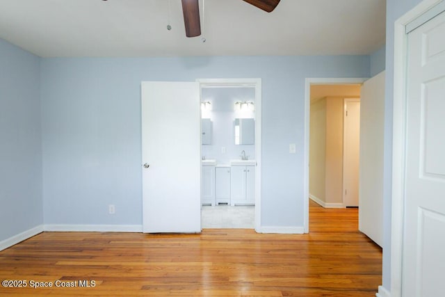 1108 Abington St, Cocoa, FL 32922 - unfurnished bedroom with wood finished floors, baseboards, and a sink