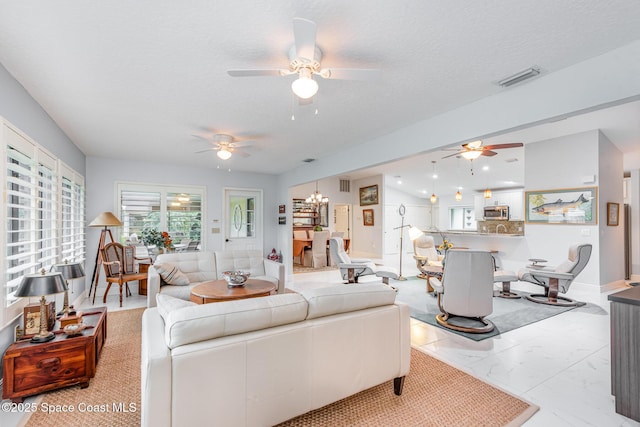 1510 Pioneer Dr, Melbourne, FL 32940 - living room featuring a ceiling fan, a textured ceiling, and marble finish floors