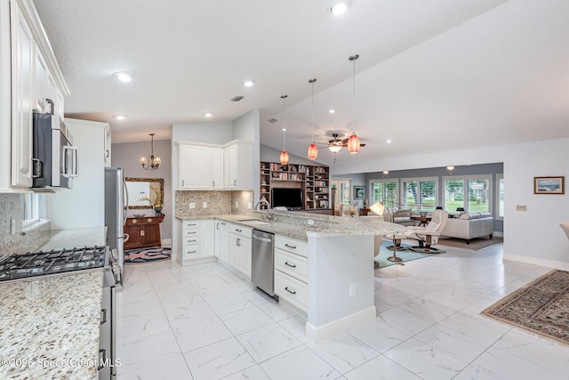 1510 Pioneer Dr, Melbourne, FL 32940 - kitchen featuring appliances with stainless steel finishes, open floor plan, a peninsula, light marble finish flooring, and lofted ceiling