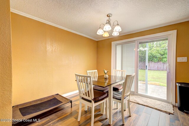 6485 Beard Ave, Cocoa, FL 32927 - dining space featuring hardwood / wood-style floors, a chandelier, ornamental molding, and a textured ceiling