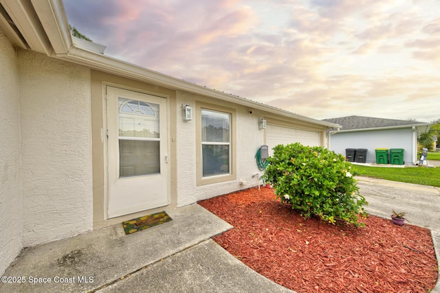 6485 Beard Ave, Cocoa, FL 32927 - view of exterior entry featuring stucco siding and an attached garage