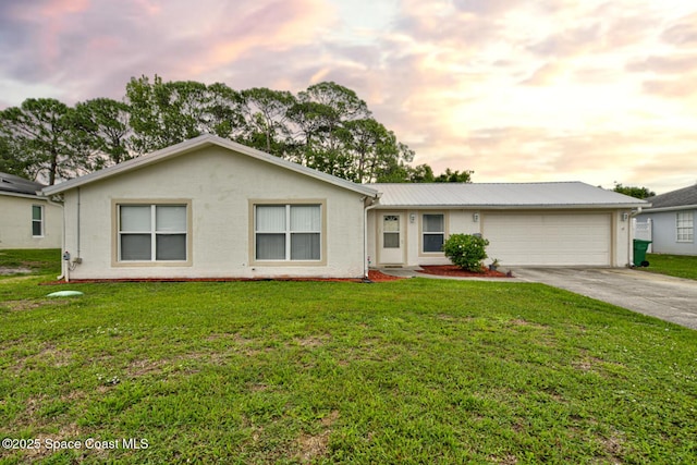 6485 Beard Ave, Cocoa, FL 32927 - ranch-style house featuring driveway, an attached garage, a front yard, and metal roof
