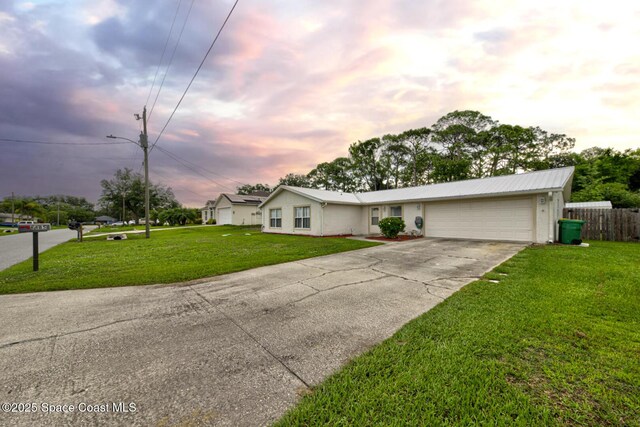6485 Beard Ave, Cocoa, FL 32927 - ranch-style home featuring an attached garage, concrete driveway, and metal roof