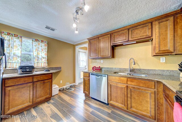6485 Beard Ave, Cocoa, FL 32927 - kitchen featuring stainless steel dishwasher, a sink, brown cabinets, a textured ceiling, and ornamental molding