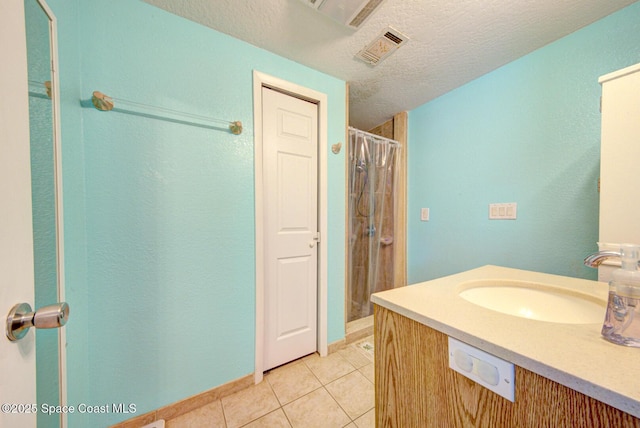 6485 Beard Ave, Cocoa, FL 32927 - full bath featuring tile patterned flooring, a textured ceiling, vanity, and a shower with curtain