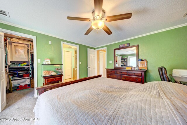 6485 Beard Ave, Cocoa, FL 32927 - carpeted bedroom featuring ornamental molding, a walk in closet, a closet, and ceiling fan