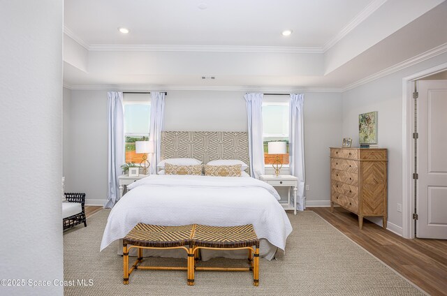 6305 Moonrise Dr, Merritt Island, FL 32953 - bedroom featuring multiple windows, wood finished floors, crown molding, a raised ceiling, and recessed lighting