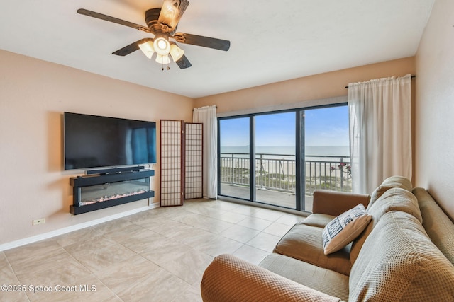 85 S Atlantic Ave Unit 403, Cocoa Beach, FL 32931 - living room with ceiling fan, baseboards, and tile patterned flooring