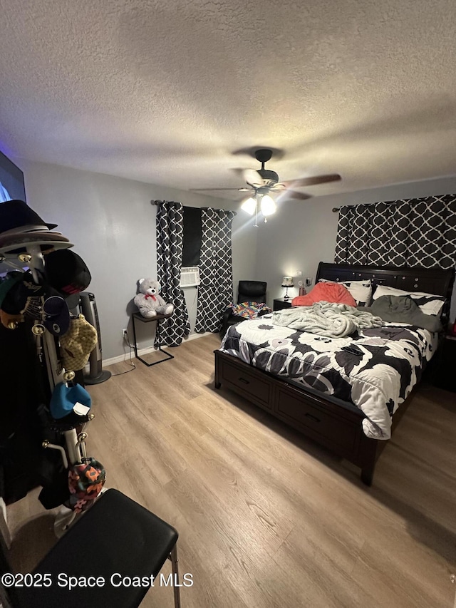 140 Cottrell Ave, Cocoa, FL 32927 - bedroom featuring a textured ceiling, light wood-style flooring, a ceiling fan, and baseboards