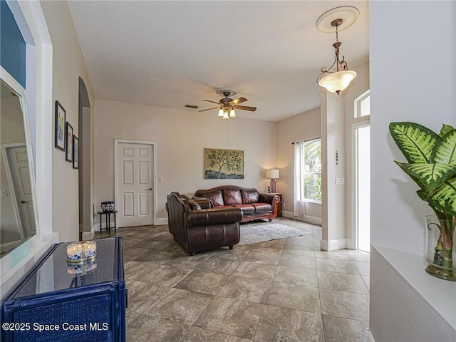 5151 4th Pl, Vero Beach, FL 32968 - living room featuring a ceiling fan and baseboards