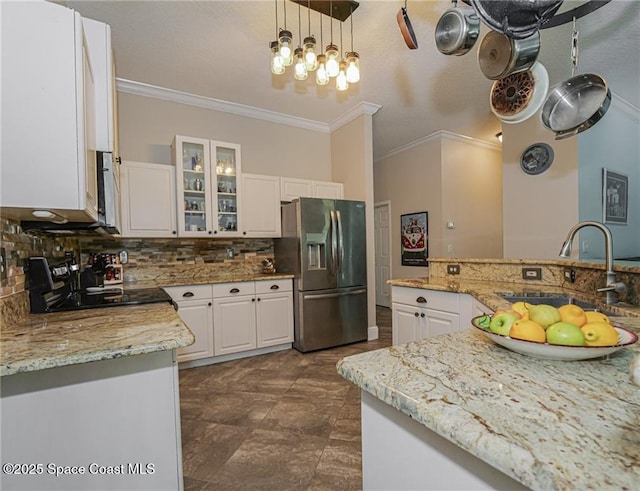 5151 4th Pl, Vero Beach, FL 32968 - kitchen with stainless steel fridge, a sink, crown molding, backsplash, and white cabinetry