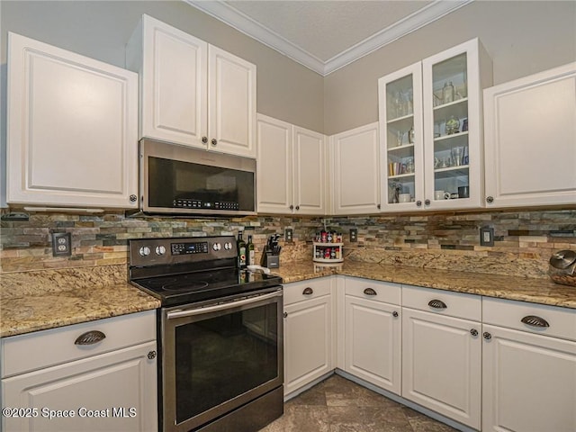 5151 4th Pl, Vero Beach, FL 32968 - kitchen with stainless steel electric range oven, crown molding, white cabinetry, tasteful backsplash, and glass insert cabinets