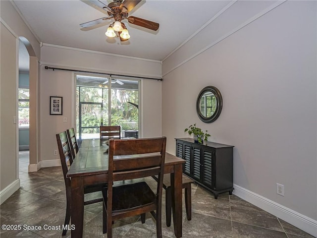 5151 4th Pl, Vero Beach, FL 32968 - dining room featuring crown molding, baseboards, ceiling fan, and arched walkways