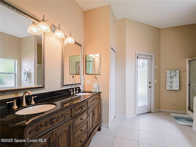 5151 4th Pl, Vero Beach, FL 32968 - full bathroom with double vanity, tile patterned floors, an enclosed shower, and baseboards