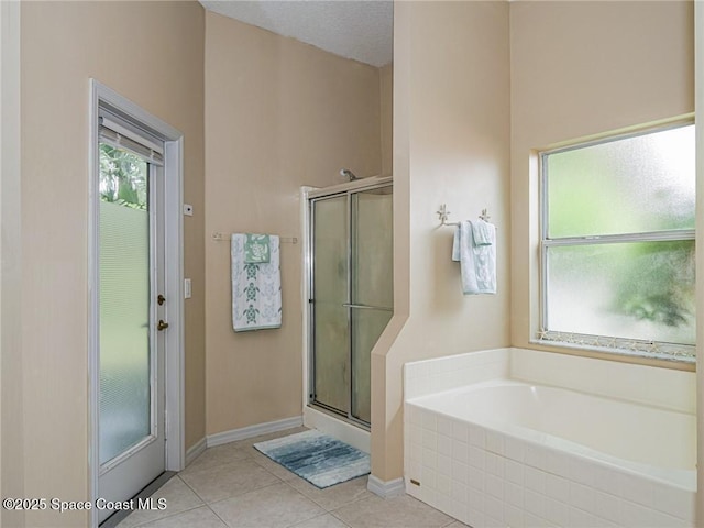 5151 4th Pl, Vero Beach, FL 32968 - bathroom with a bath, a stall shower, and tile patterned flooring