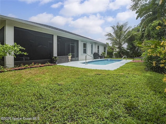 5151 4th Pl, Vero Beach, FL 32968 - rear view of property featuring a sunroom, an outdoor pool, a lawn, and stucco siding