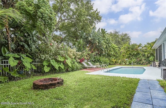 5151 4th Pl, Vero Beach, FL 32968 - view of green lawn featuring an outdoor fire pit, an outdoor pool, and a patio area