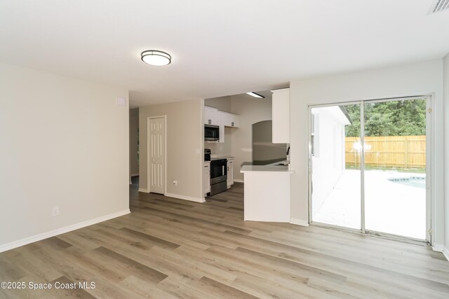 366 Reading St SE, Palm Bay, FL 32909 - unfurnished living room featuring light wood-style floors and arched walkways